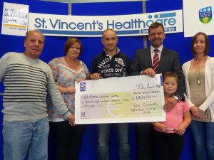 John Summers (Centre) alone with his father John, Wife Frances, daughter Holly and sister Joan present his fundraising proceeds to John Hickey